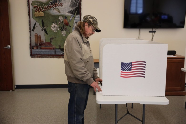 Daniel Brand casts his ballot on Nov. 8, at the Sheboygan Falls, Wis., town hall during the midterm elections.