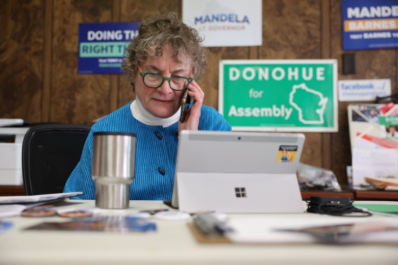 Mary Lynne Donohue talks on the phone with the Sheboygan city clerk.